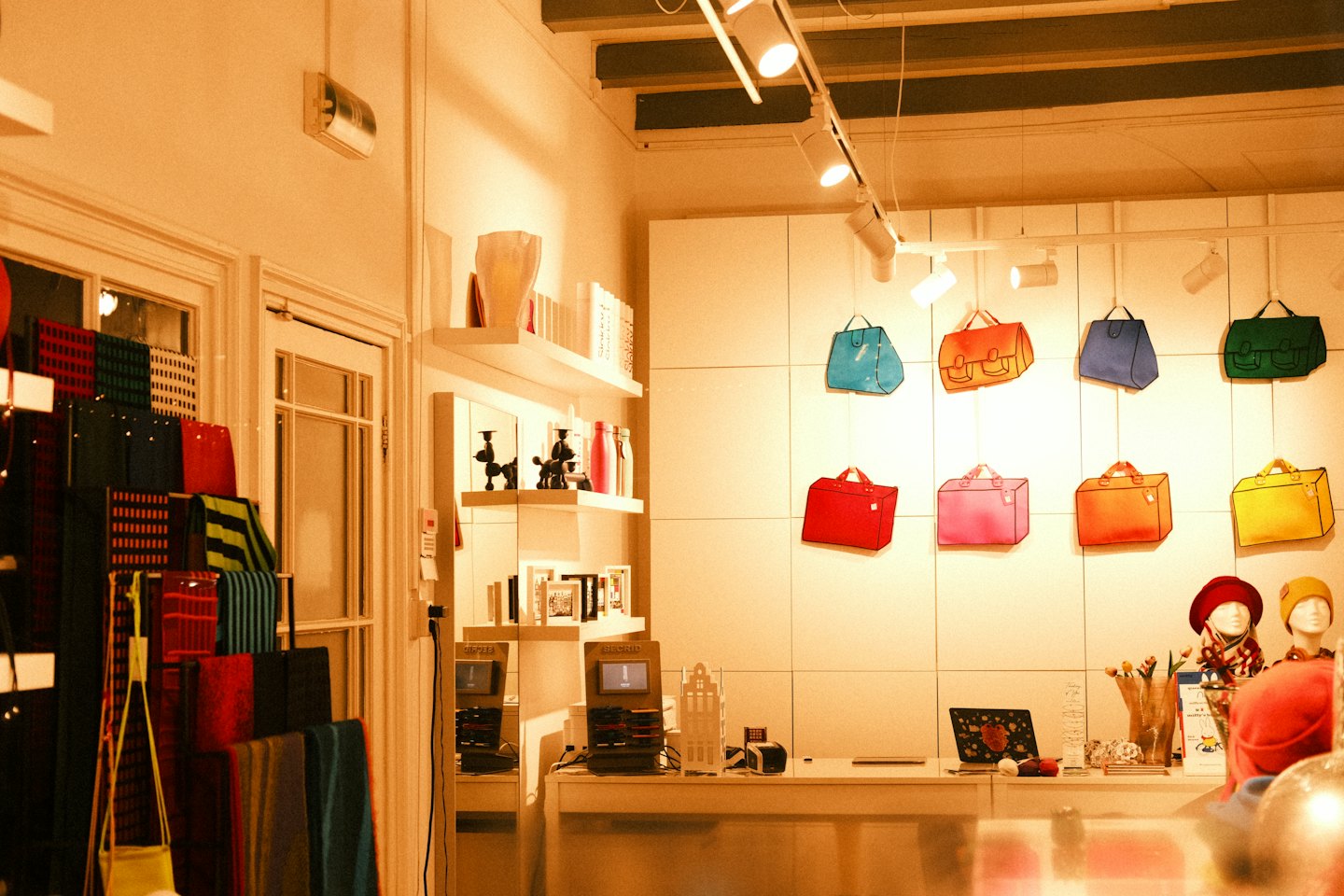 Interno di una boutique con borse esposte sopra un bancone.
